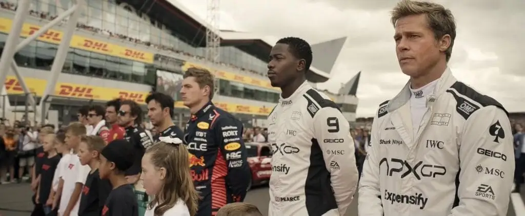 Scene from F1 movie. Line up featuring F1 professional drivers. Image courtesy of Apple Original Films, Warner Bros., and the official production partners.